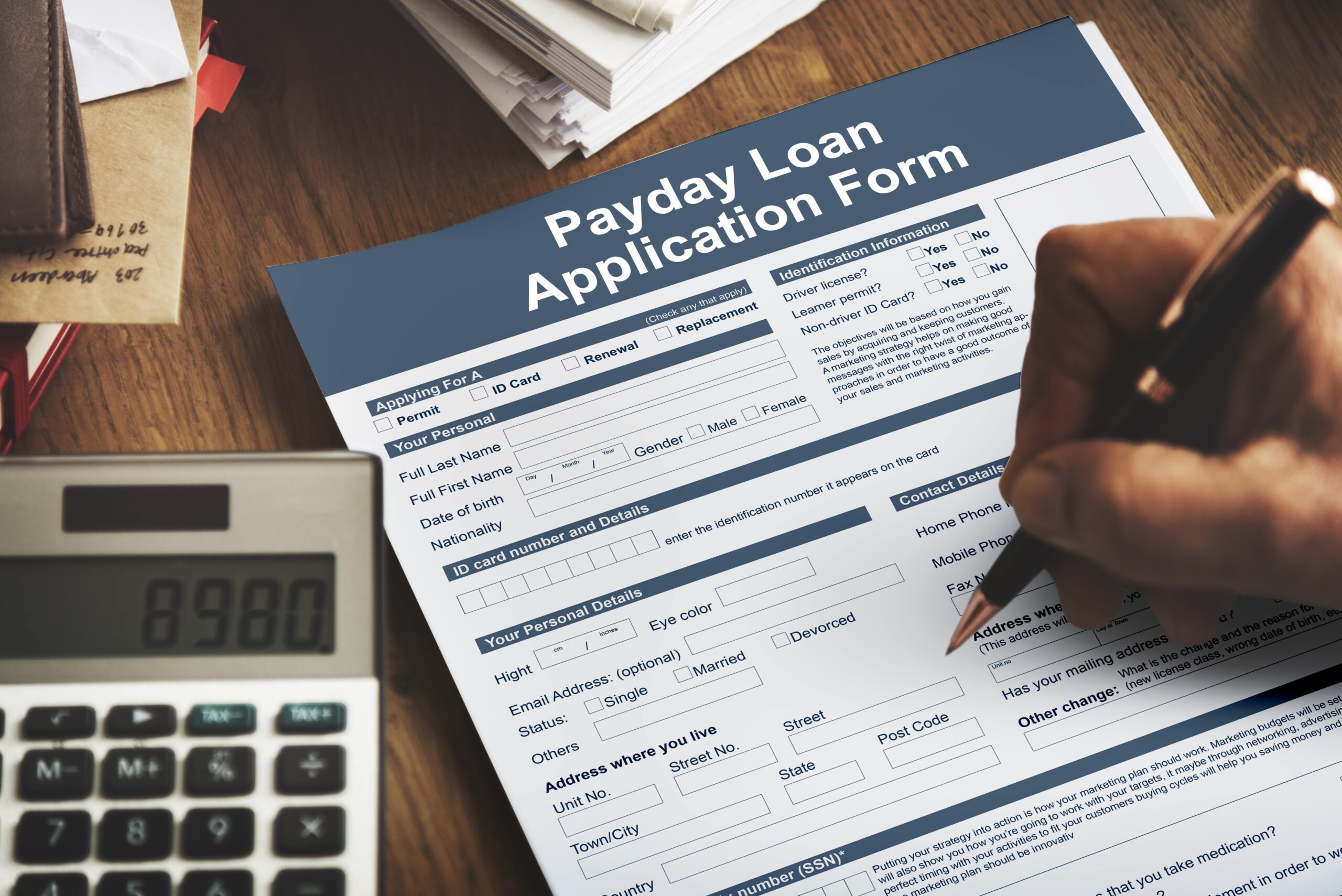 A man filling out a payday loan application form thinking about payday loan debt 