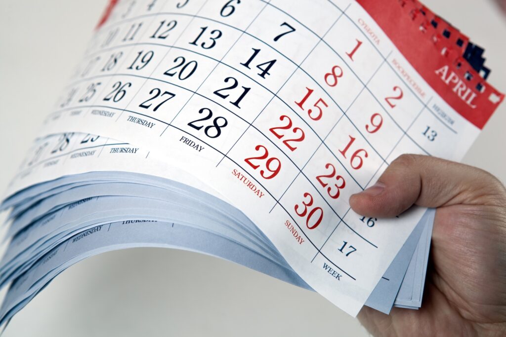 A man holding lots of calendars to show how long does an iva last