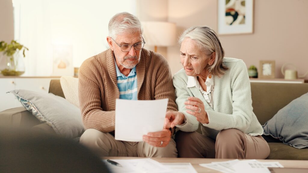 A senior couple looking at their debts and wondering if they can use their pension to pay off debt