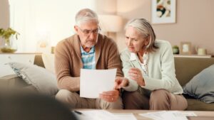A senior couple looking at their debts and wondering if they can use their pension to pay off debt