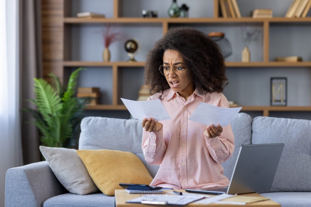 A woman holding documents unsure if you can get a mortgage with a ccj